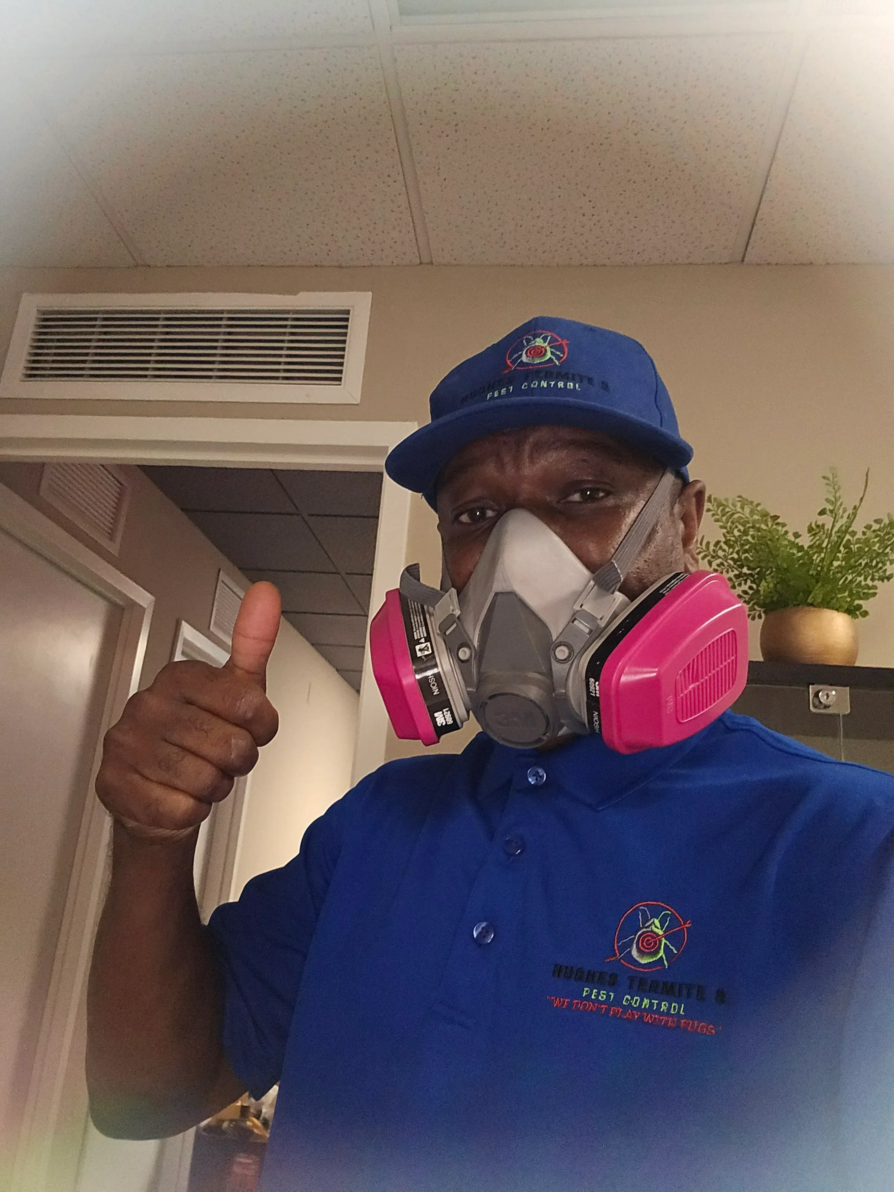Pest control technician using detection equipment to inspect ceiling and HVAC areas during residential inspection